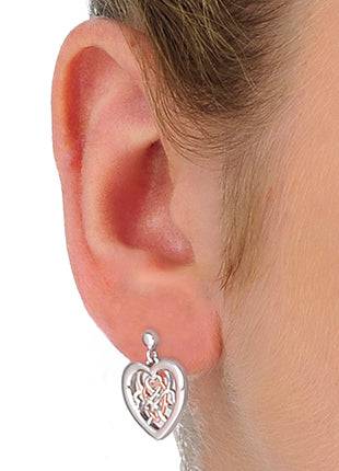 A woman's ear with Clogau Welsh Royalty Heart Stud Earrings 3SWLRE.