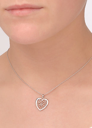 A woman wearing a Clogau Welsh Royalty Heart Pendant 3SWLRP necklace with a heart shaped pendant.