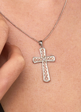 A woman wearing a Clogau Welsh Heritage Cross Pendant 3SWRWCP necklace.