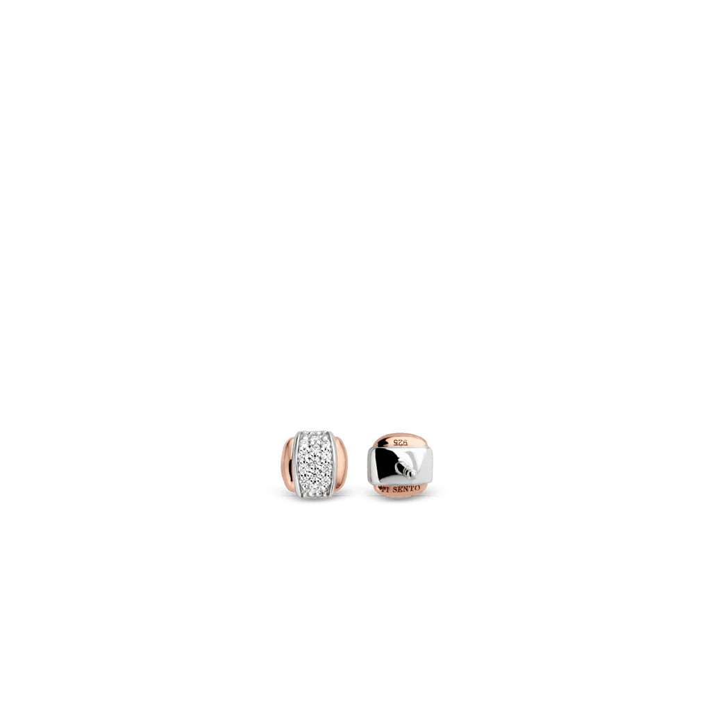 A pair of TI SENTO – STUD EARRINGS 7799ZR with diamonds on a black background.