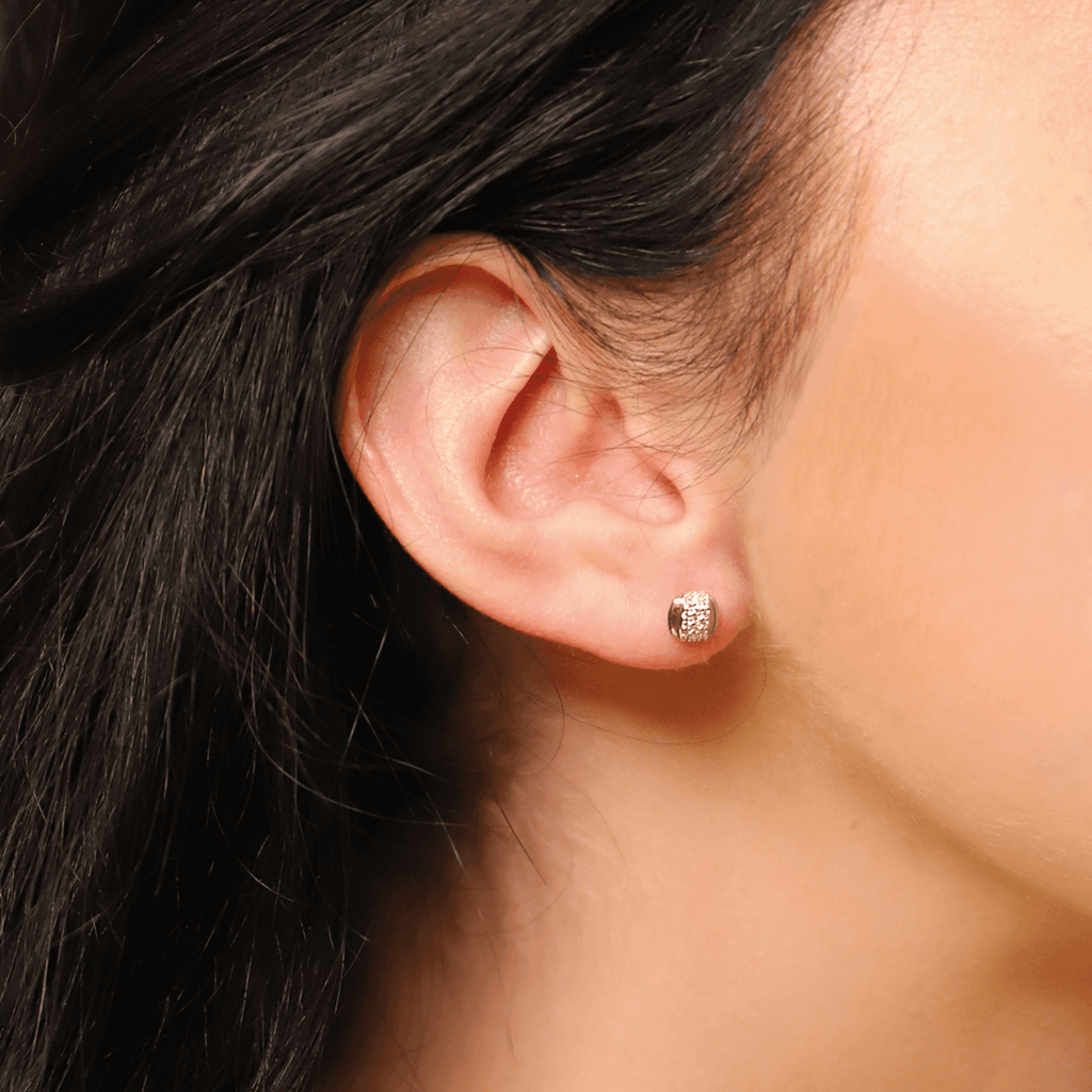 A woman's ear with a TI SENTO – STUD EARRINGS 7799ZR earring.