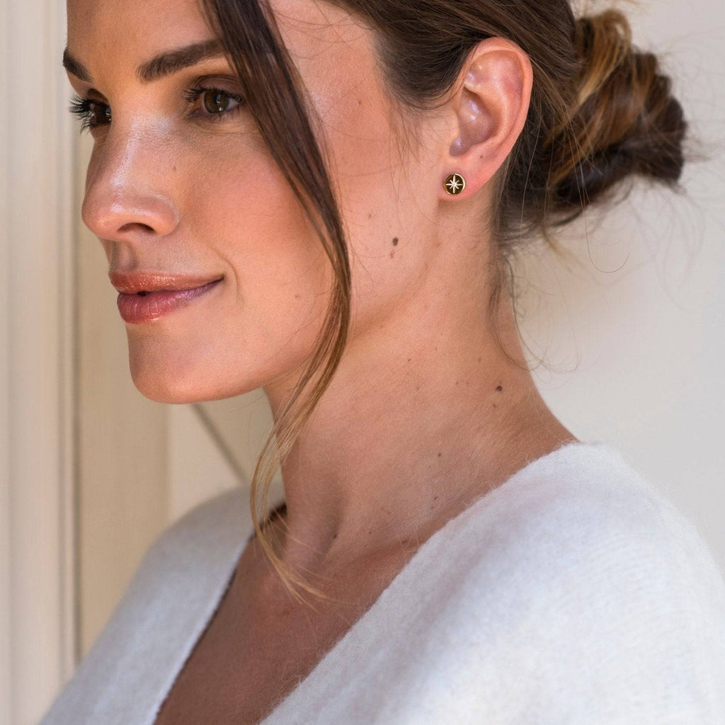 A woman wearing a white sweater and TI SENTO – STUD EARRINGS 7822ZY.