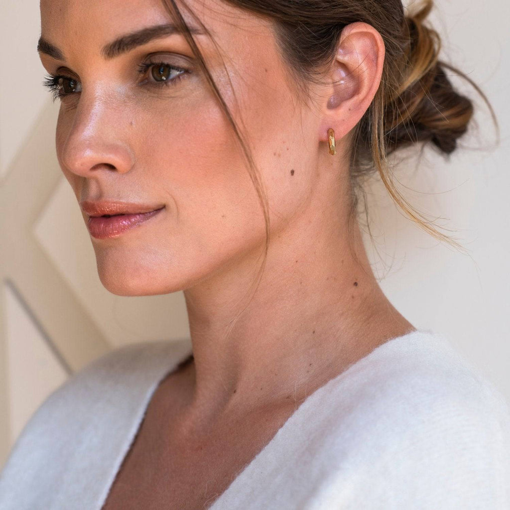 A woman wearing TI SENTO Milano Earrings in a white shirt.