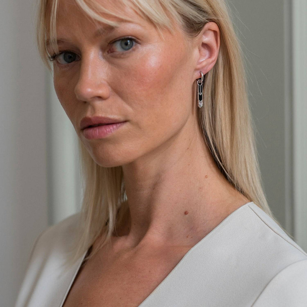A woman wearing a white shirt and TI SENTO Milano Ear Charms 9225 earrings.