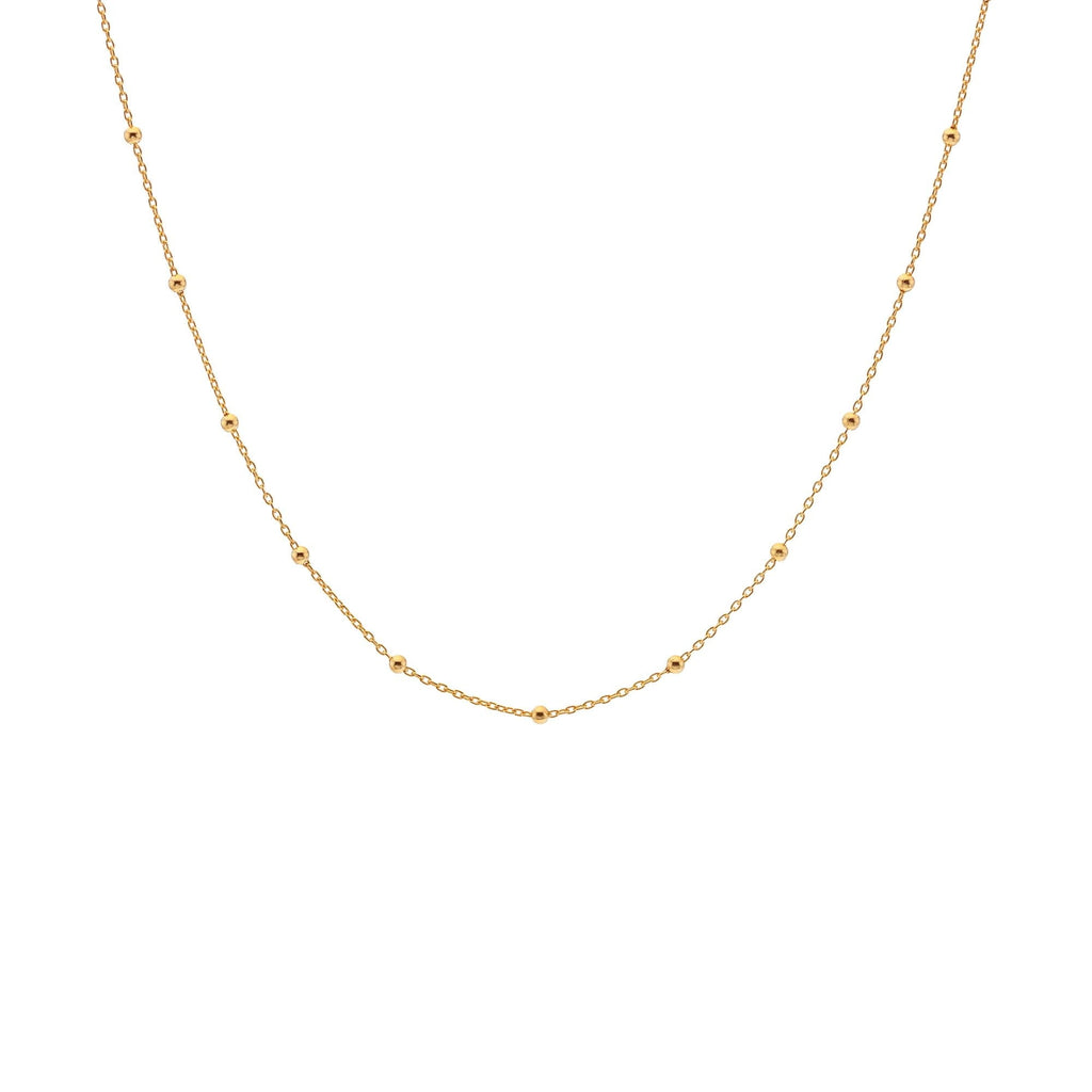 A Hot Diamonds X Jac Jossa Embrace Beaded Cable Chain necklace with a few gold balls on it.