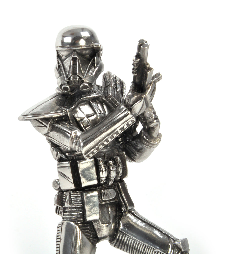 A Death Trooper Star Wars Figurine 017918R of a person in a garment holding a gun.