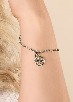 A woman wearing a Clogau Gold Tree of Life Bracelet GTOL0017 with a charm on it.