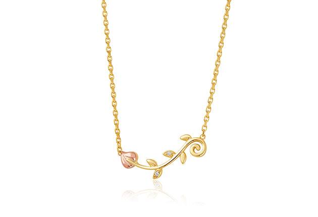 A Vines of Life Diamond Necklace with a pink flower on it.
