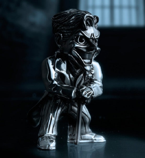 A Joker Mini Figurine 017971R sitting in a dark room.