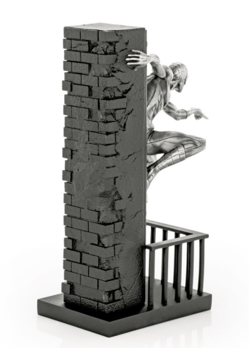 A Limited Edition Spider-Man Figurine 017938 is leaning against a brick wall.