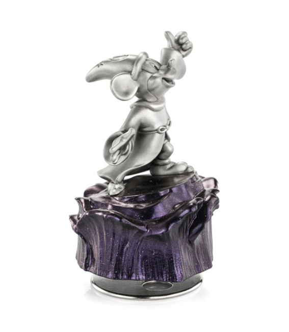 A figurine of Mickey Mouse Sorcerer Music Carousel 016316 sitting on top of a purple rock.