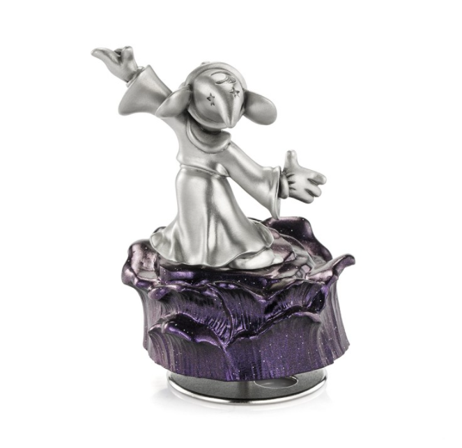 A statue of the Mickey Mouse Sorcerer Music Carousel 016316 on top of a purple rock.