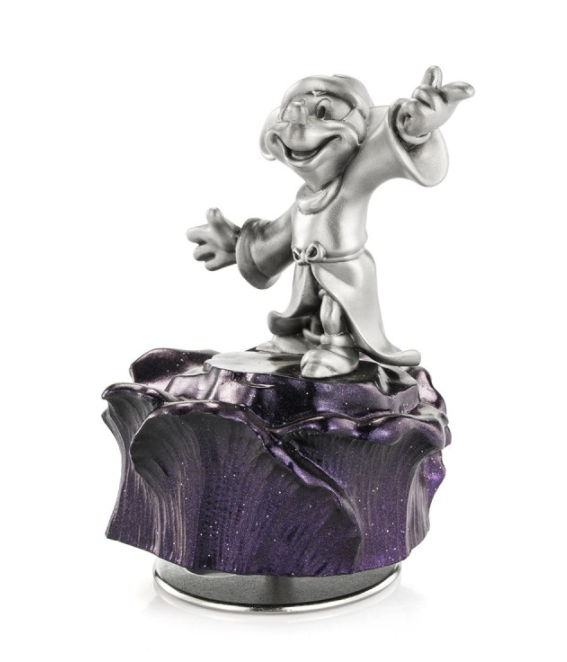 A figurine of Mickey Mouse Sorcerer Music Carousel 016316 sitting on top of a purple flower.