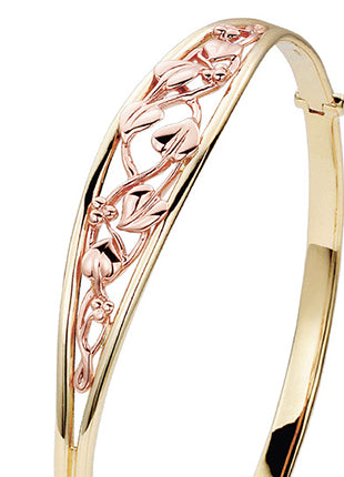 A CLOGAU Tree of Life® Bangle TLB with a floral design.