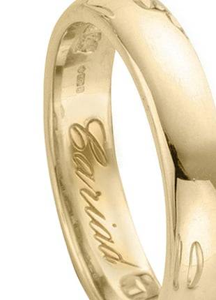 A Clogau Gold Welsh Wedding Ring. 4mm with the words 'love' engraved on it.