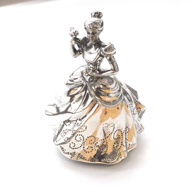 A silver figurine of Cinderella Music Carousel 016309R sitting on top of a white surface.