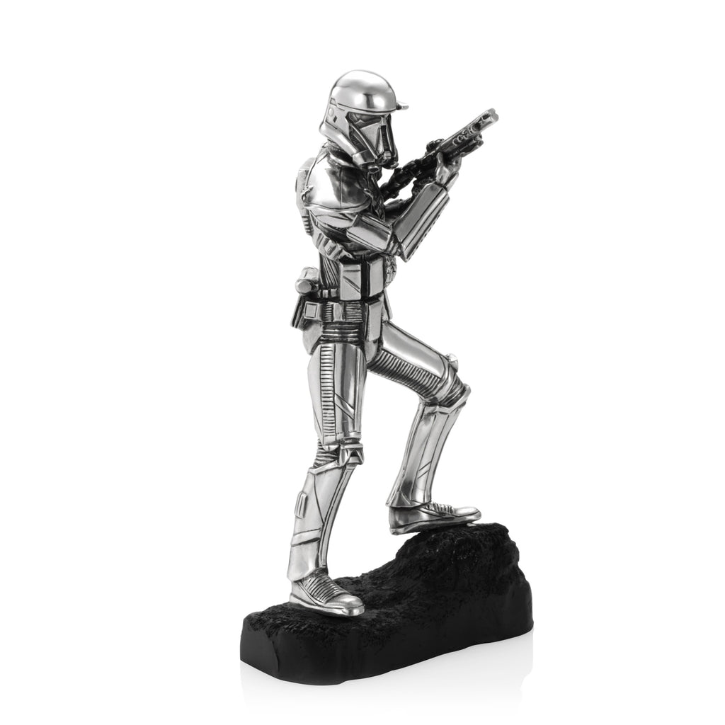 A silver statue of a Death Trooper Star Wars Figurine 017918R holding a gun.
