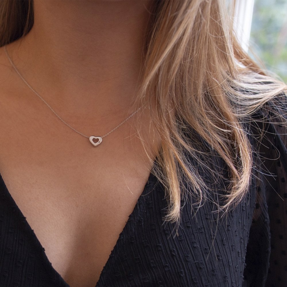 A woman wearing a Diamond Amulet Heart Pendant necklace.