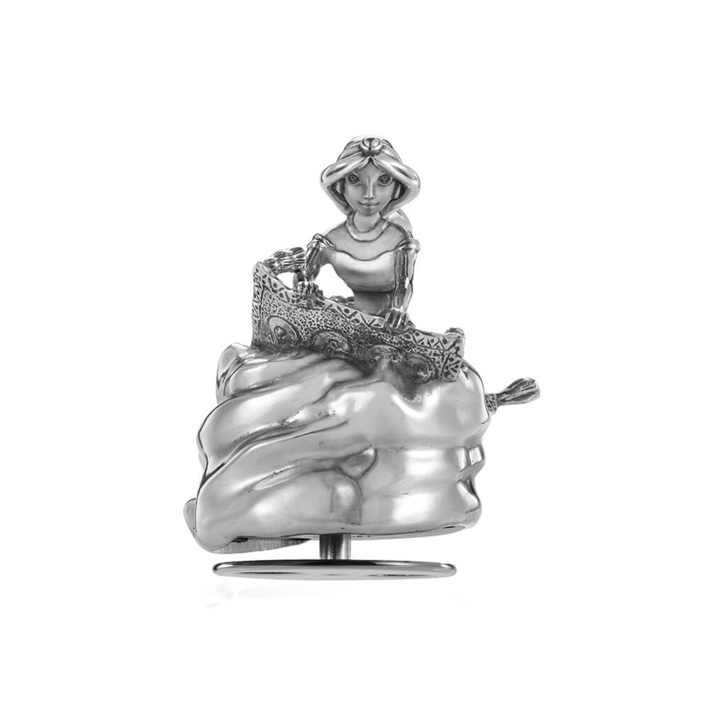 A Jasmine Music Carousel 016306R figurine of a woman sitting on a cake.