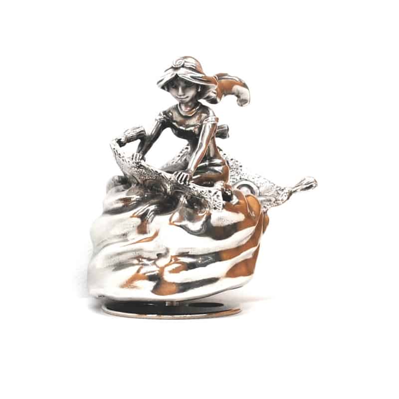 A silver Jasmine Music Carousel 016306R of a woman riding a boat.
