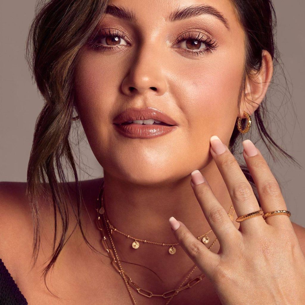 A woman posing with Hot Diamonds X Jac Jossa Believe Earrings on her finger.
