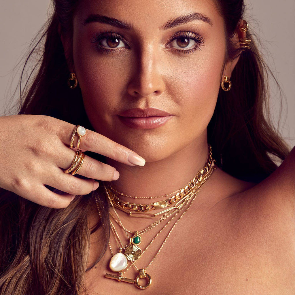 A woman with a Hot Diamonds X Jac Jossa Spirit Earrings necklace and earrings posing for a photo.